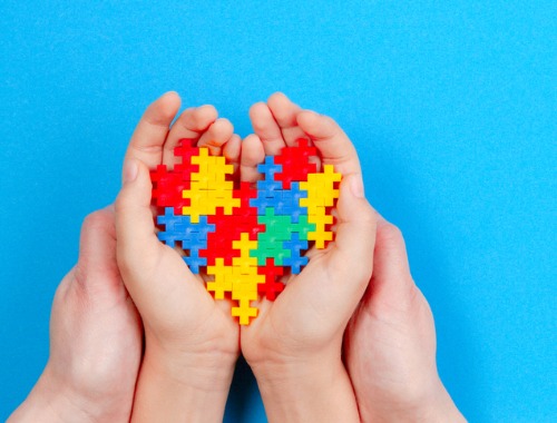 Autism Spectrum Disorder puzzle pieces in hands