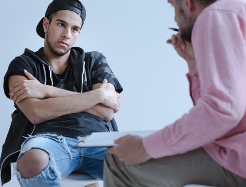 Young Man with Behavioral Issues talking to a therapist